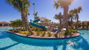 a water slide at a resort with palm trees at Moonlight Ridge - 5 bed ChampionsGate Resort pool home in Davenport