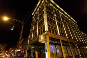 a large building on a city street at night at Hotel Covington Cincinnati Riverfront in Covington