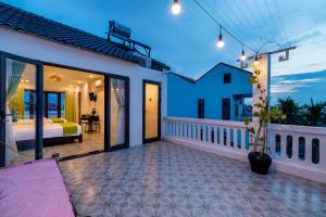 a room with a bed and a balcony at Sunny Island Homestay in Hoi An +98 photos