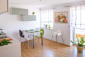 a kitchen with a table and chairs in a room at Apartment 3 in Gottmadingen