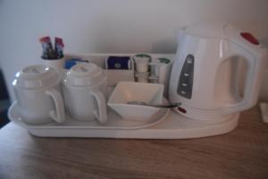 a white tea kettle and cups on a tray at Borthwenbnb in Dolgellau