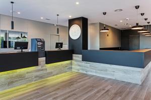 an office with a reception desk and a counter at B&B HOTEL Oviedo in Viella
