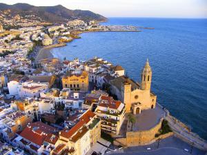 an aerial view of a town next to the ocean at Melia Sitges in Sitges