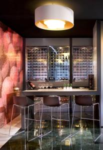 a wine cellar with a bar and stools at Melia Sitges in Sitges