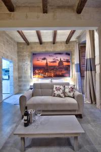a living room with a couch and a table at Laparelli Suites: Luxury Suite 2 in Valletta