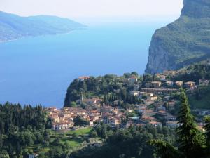 a small town on a hill next to the water at Hotel Garni Bel Sito in Tremosine Sul Garda