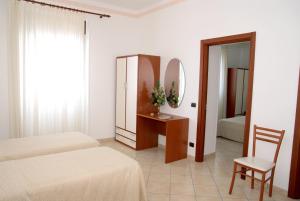 a bedroom with two beds and a mirror and a chair at Il Mulino in Furore