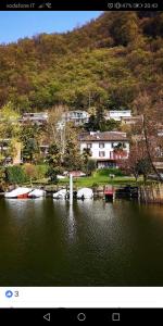 a picture of a lake with boats in the water at B&B MANITO in Lavena Ponte Tresa