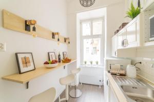 a kitchen with white walls and a counter with a sink at Rumbach Residence in Budapest +34 photos