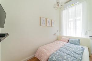 a bedroom with a bed and a window at Rumbach Residence in Budapest