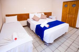 Postel nebo postele na pokoji v ubytování Rede Andrade Estrela Dalva Centro Hotel