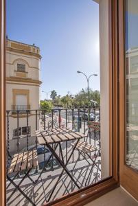 a view from a window of a building with chairs at Ohliving Santa Cruz in Seville