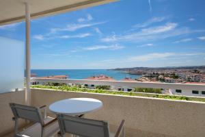 a balcony with a table and chairs and the ocean at Melia Sitges in Sitges