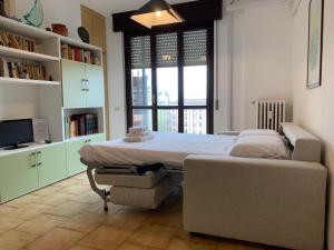 a bedroom with two beds and a large window at Kibilù - Via Cimabue in Milan