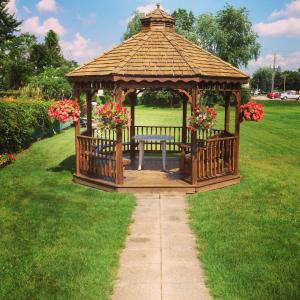 a gazebo with a bench in the grass at Majers Motel in Stratford