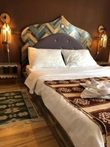a bedroom with a large bed with a wooden headboard at Guest House Adriatica by Pinch in Pakoštane