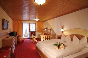 a hotel room with a bed with flowers on it at Hotel Bergheimat in Schönau am Königssee