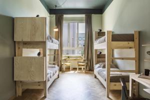 a small room with bunk beds and a desk at casaBASE in Milan