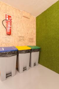 a row of tables in a room with green walls at Tomate Rooms in Alicante