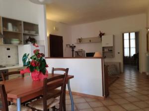 a kitchen and dining room with a wooden table and a table at a casa di renata in Monterosso al Mare