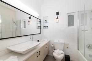 a white bathroom with a sink and a toilet at Yehuda Central Park by TLV2RENT in Tel Aviv +27 photos