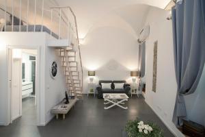 a living room with a staircase and a couch at La Casa Bianca in Florence