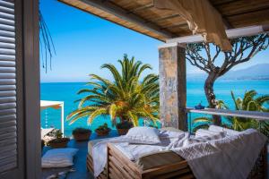 a bedroom with a view of the ocean at Skajado Holiday Apartments in Stalida