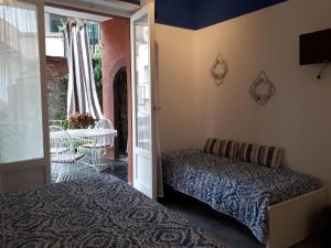 a bedroom with two beds and a balcony with a table at Il Sogno Apartments in Monterosso al Mare