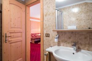 a bathroom with a sink and a mirror at B&B Residence Adria in Corvara in Badia +22 photos