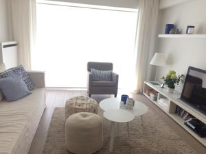 a living room with a couch and a table at Residentie TYL - Leopoldlaan 122 in Knokke-Heist