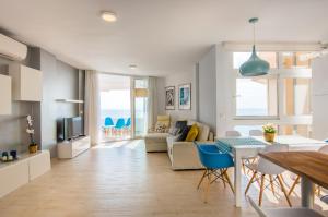 a living room with a kitchen and a dining room at Seafront La Malagueta I in Málaga