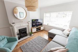 a living room with a couch and a tv at Moda Stays - Oxford House in Birmingham