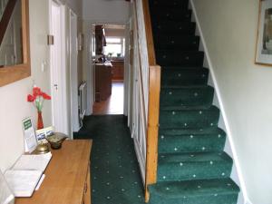 a row of stairs leading up to a living room at Green Haven Guest House in Stratford-upon-Avon