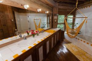 a bathroom with two sinks and a hammock in it at Roatan Bed & Breakfast Apartments in West End