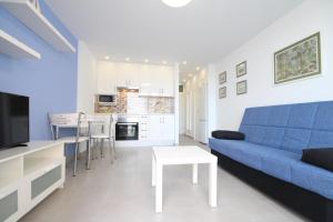 a living room with a blue couch and a table at Apartment with terrace in Playa de Las Americas in Playa de las Americas