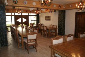 a dining room with wooden tables and chairs at Cabana Iza in Bîrsana
