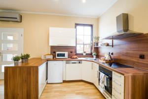 a kitchen with white appliances and wooden counters at Hotel Bonsai in Mikulov