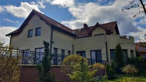 a large white house with a brown roof at Villa Mechelinka in Mechelinki