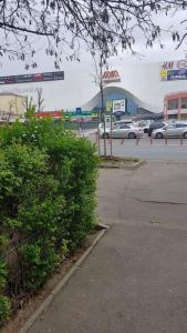 a parking lot with cars parked in front of a building at Eden Apartament in Bucharest