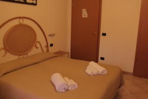 1 dormitorio con 2 camas y toallas. en Albergo Il Terrazzino, en Vibo Valentia Marina
