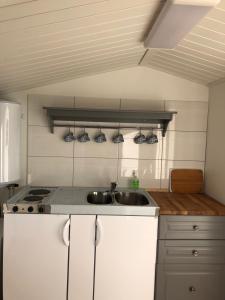 a kitchen with a sink and a counter top at Two small Guest houses by lake rent out as One in Hjo