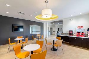 a restaurant with tables and chairs and a counter at Motel 6 Austin Airport in Austin