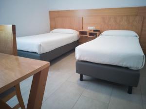 Postel nebo postele na pokoji v ubytování Hotel Abadi