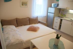 a small living room with a couch and a table at Babe beach Apartment in Novalja