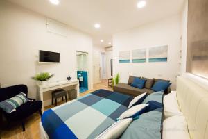 a bedroom with a bed and a living room at Sea House Porto Ercole in Porto Ercole