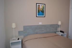Postel nebo postele na pokoji v ubytování Hotel La Tavernetta