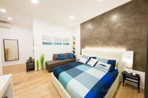 a bedroom with a bed and a couch at Sea House Porto Ercole in Porto Ercole