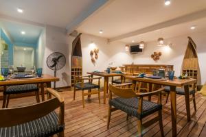 a restaurant with wooden tables and chairs and a clock at 33 Lake Terrace in Hikkaduwa