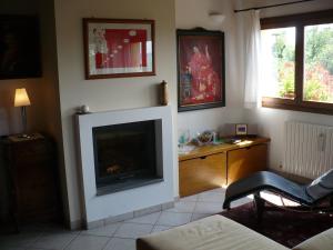 a living room with a fireplace and a television at Solo Per Quattro in Zocca
