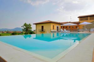 a large swimming pool in front of a house at Corte Lantieri in Capriolo